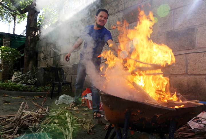 A worker burns old palm fronds that was used in last year's Ash Wednesday at the St. Peter Church in Quezon City, February 17, 2015, in preparation for this year's Ash Wednesday tomorrow. In the Roman Catholic Church, Ash Wednesday is the first day of Lent, the season of preparation for the resurrection of Jesus Christ on Easter Sunday. (Mark Balmores)